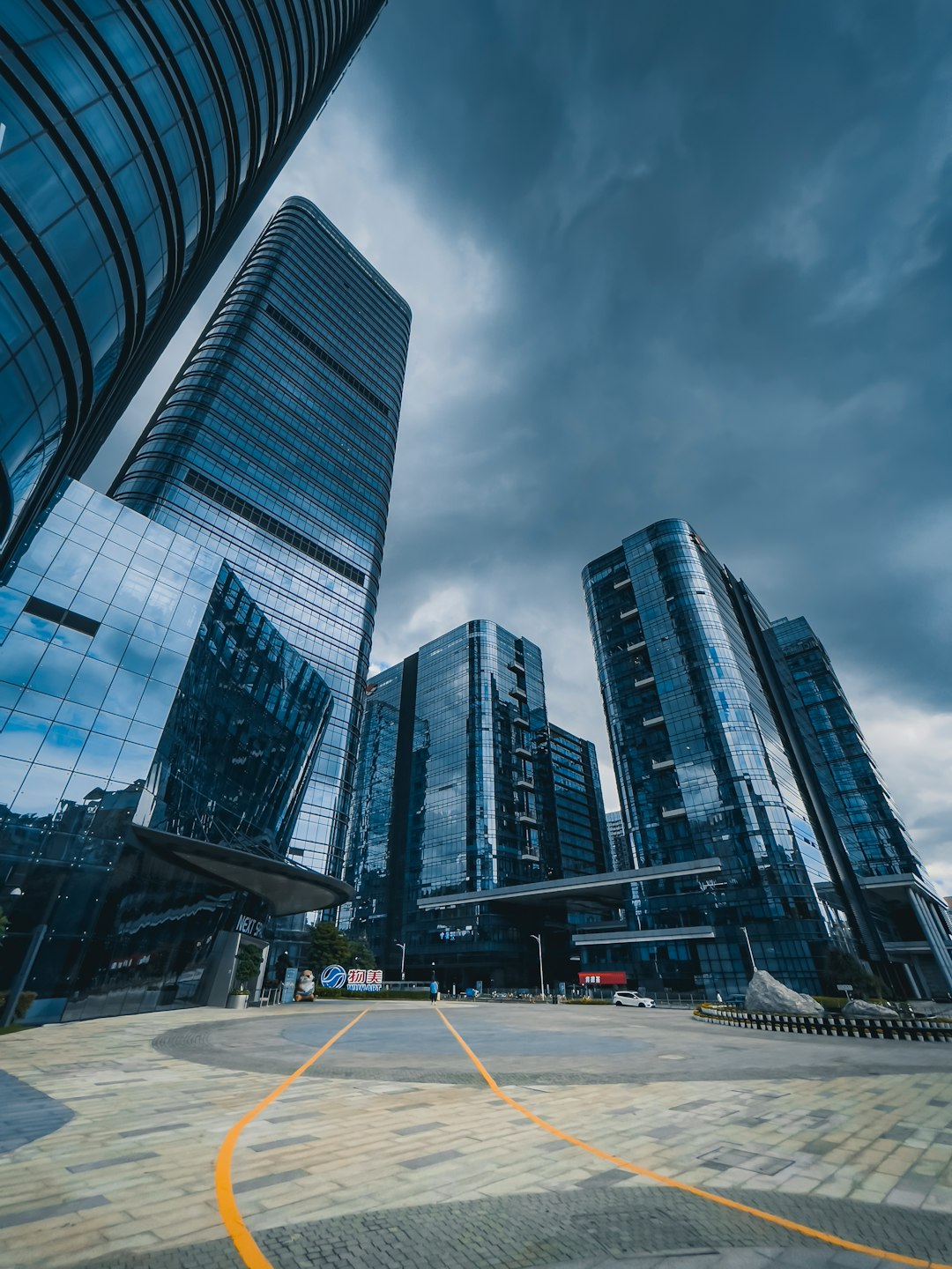 who-we-are a-group-of-tall-buildings-sitting-next-to-each-other-3-dkzkg-ybo